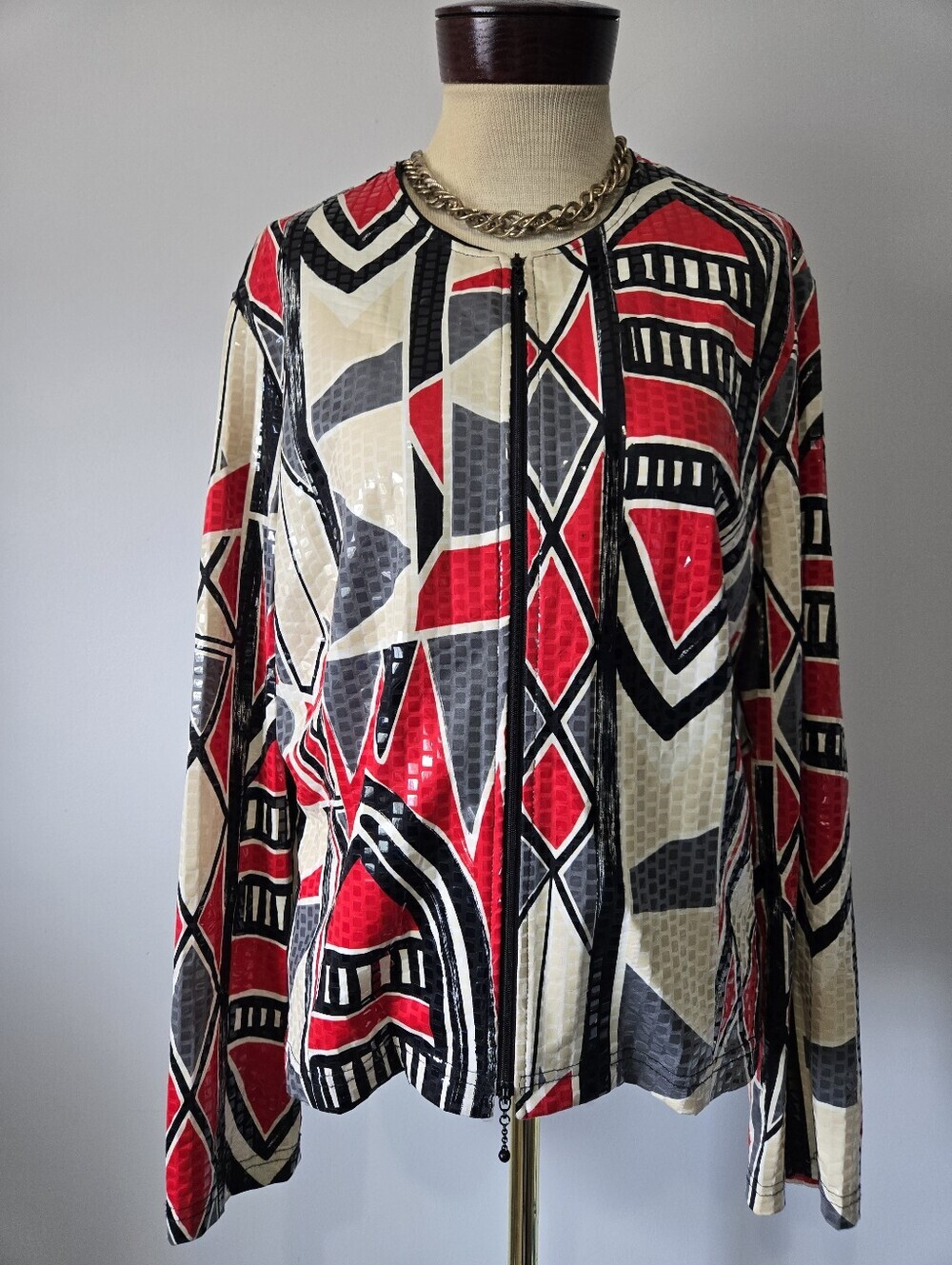 Joseph Ribkoff abstract sequin jacket features a vibrant red, black, Beige.
